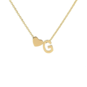Detail of 18k gold plated heart necklace featuring a stylized G letter pendant