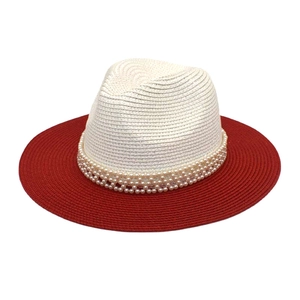 Close-up of summer straw hat featuring two-tone weaving and elegant pearl chain trim