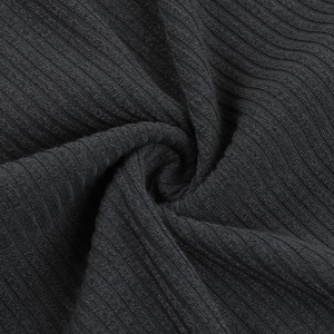 Detailed close-up of premium black ribbed knit fabric texture and elegant material drape