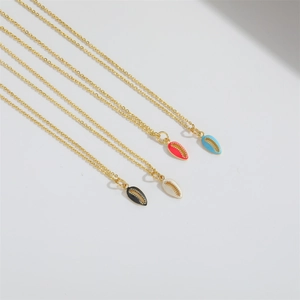 Macro view of minimalist star shell pendants in black white red and blue on gold chains