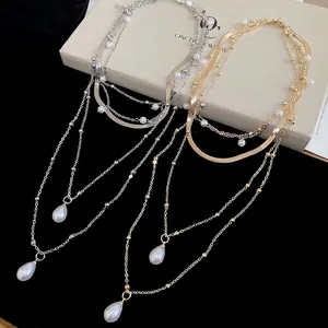 Elegant layered pearl necklace with water drop pendant in gold and silver finish