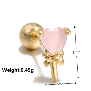 Macro shot of pink heart zircon stud earring with gold bow detail and screw back