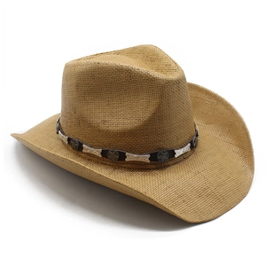 Vintage khaki straw cowboy hat with leather band and metal star accents on white background