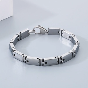 Detailed macro view of silver tungsten steel bracelet featuring rectangular links and clasp