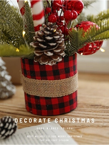 Close-up of Christmas centerpiece with pine cones, berries and candy canes decoration