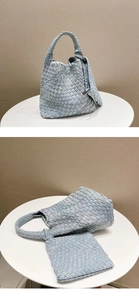 Detailed close-up of light blue denim woven tote bag with iconic knotted handle design