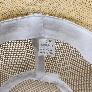 Macro detail of breathable mesh sun hat with 100% paper material and size 58 label