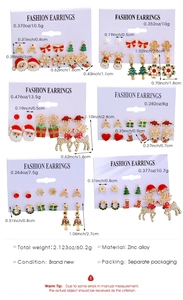 Detail of Christmas earring set showing Santa and reindeer designs in zinc alloy