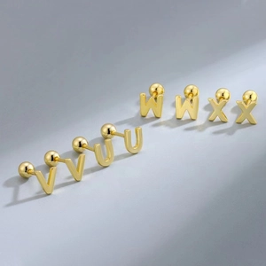 Detail of golden stainless steel letter earrings V, U, W, X with secure screw ball backs