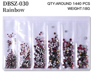 Macro view of rainbow nail rhinestones in a six-compartment box with technical specs