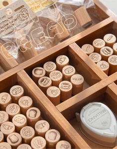 Close-up of wooden bakery stamps in a storage box with a moonlight white ink pad