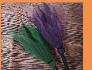 Detail of purple and green mesh witch brooms for kids' Halloween costume party props