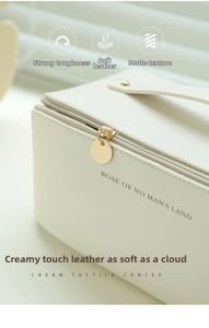 Close-up of cream white lychee texture leather makeup bag with gold metal zipper
