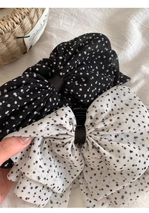 Detail of large French vintage polka dot chiffon bow hair clips in black and white