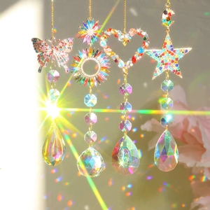 Set of four crystal suncatchers with butterfly and heart shapes reflecting rainbow light