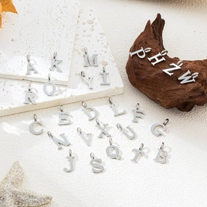 Detailed arrangement of 26 silver stainless steel letter pendants for DIY jewelry