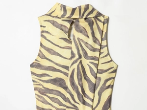 Detail of zebra print sleeveless dress featuring a standing collar and back keyhole closure