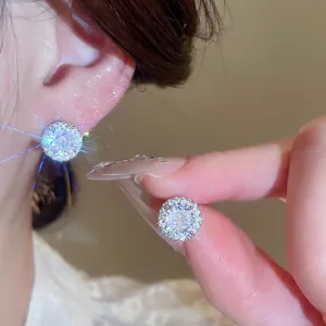 Elegant silver stud earrings featuring brilliant round-cut zirconia stones with pavé halo