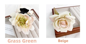 Close-up of silk rose hair claws in grass green and creamy yellow on a tray