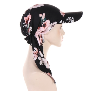 Detail of floral headscarf hat with pink flowers and a long silk-like ribbon tie back