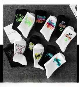 Detailed view of mid-calf sports socks with street graffiti patterns and ribbed cuffs