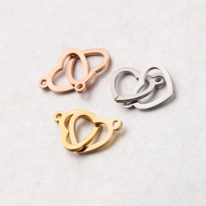 Macro detail of intertwined heart charms in gold, silver, and rose gold stainless steel