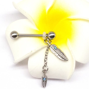 Detail of silver nipple ring featuring delicate feather charms with light blue crystals