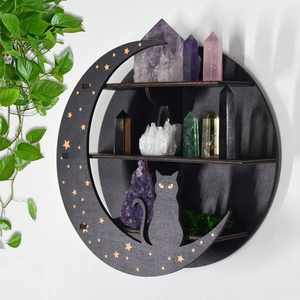 Detail of black moon cat wooden crystal shelf featuring gold stars and crystal display