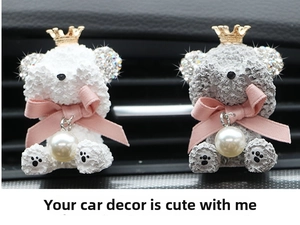 Close-up of diamond-studded bear car vent clips with golden crowns and pearl charms