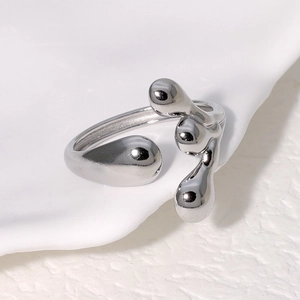 Macro detail of irregular silver lava-style adjustable stainless steel ring on porcelain