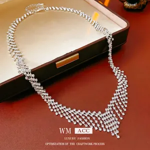 Sparkling silver fringe tassel necklace with layered rhinestones on luxury jewelry box