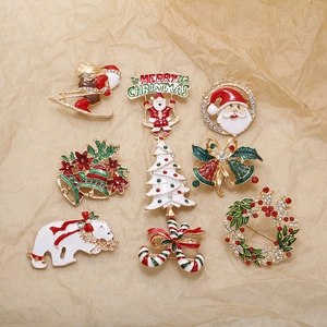 Set of 8 colorful Christmas brooches featuring Santa, reindeer and tree on vintage paper