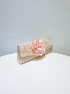 Elegant champagne pleated evening clutch bag featuring a stunning pink fabric rose flower.