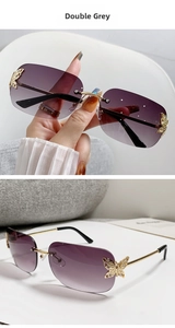 Macro detail of rimless sunglasses with gold butterfly accent and double grey gradient lenses