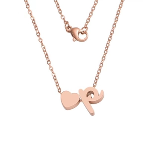 Macro detail of rose gold heart pendant and lowercase p letter charm on a thin link chain