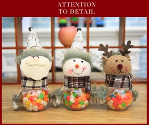 Detailed view of three festive Santa, Snowman, and Reindeer candy jars with plush heads