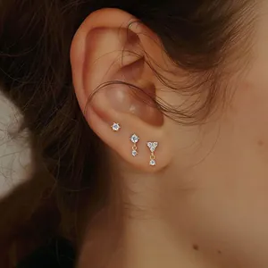 Macro shot of 925 sterling silver gold earrings set with heart shaped zircon stones