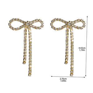 Detailed view of bow earrings with size info 4.43cm height and 2.76cm width
