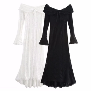 Detailed view of lace texture on off-shoulder long dresses in black and white colors