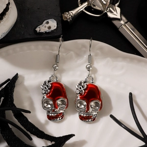 Gothic skull earrings with red drip accents for Halloween, displayed on white tray
