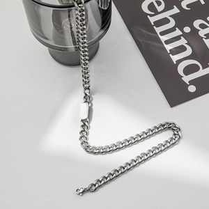 Detail of silver titanium steel Cuban chain with blank ID plate and lobster clasp