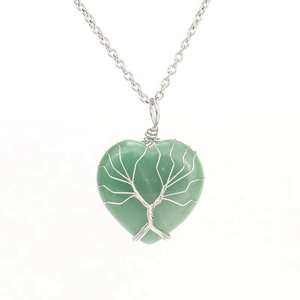 Detail view of handmade silver wire wrapped heart green stone tree of life pendant necklace
