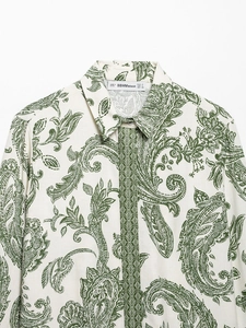 Detail of green paisley print on cotton-linen long sleeve shirt with vintage patterns