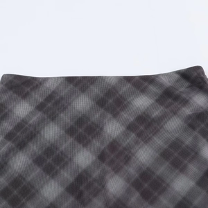 Close-up of black and grey plaid mesh fabric showing detailed sheer net texture and pattern