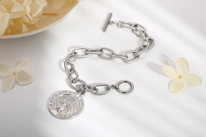 Silver link chain bracelet with Virgin Mary coin pendant and toggle clasp detail