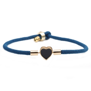 Adjustable dark blue braided cord bracelet with a gold-edged black heart pendant charm