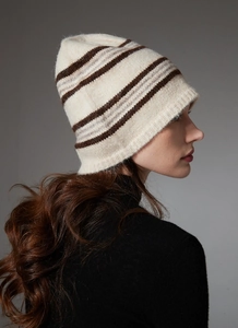 Profile view of a model wearing a striped cream and brown wool knitted beanie hat
