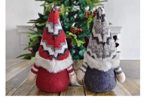 Vue arrière de gnomes de Noël avec bonnets tricotés, barbe en peluche et bois