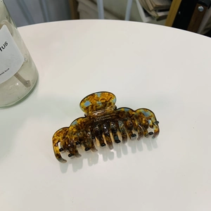 Macro shot of French style amber tortoiseshell hair claw with Barrette La France text