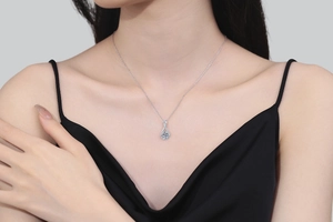 Elegant 925 silver necklace with teardrop pendant worn on a female neck for fashion detail